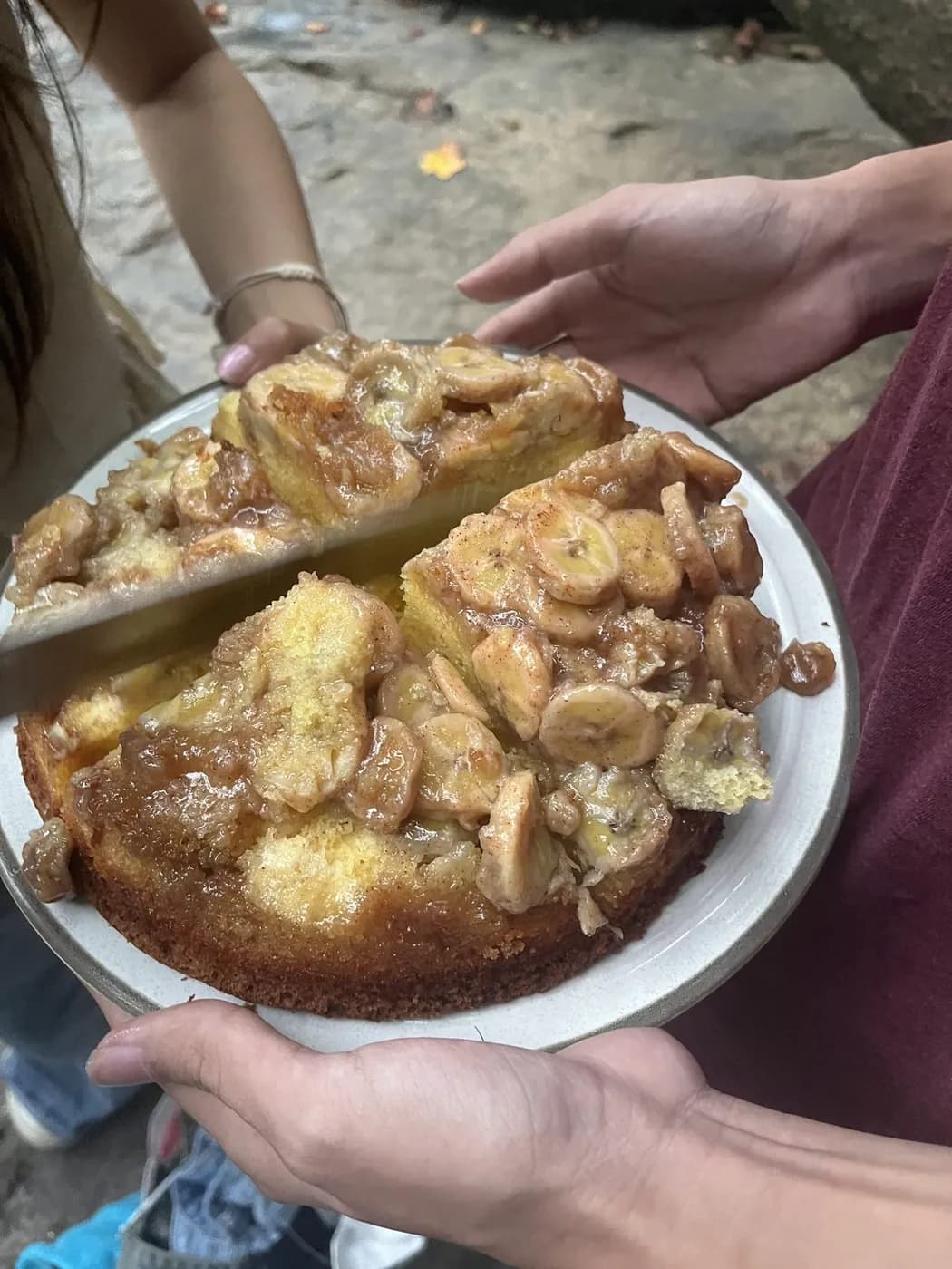 A banana upside-down cake being cut