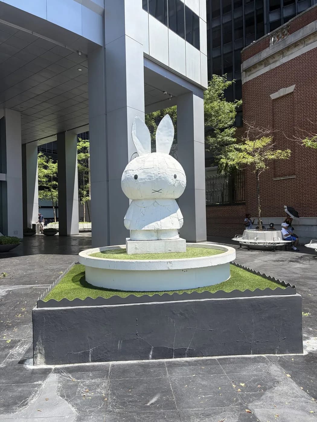 A white rabbit sculpture in a courtyard fountain
