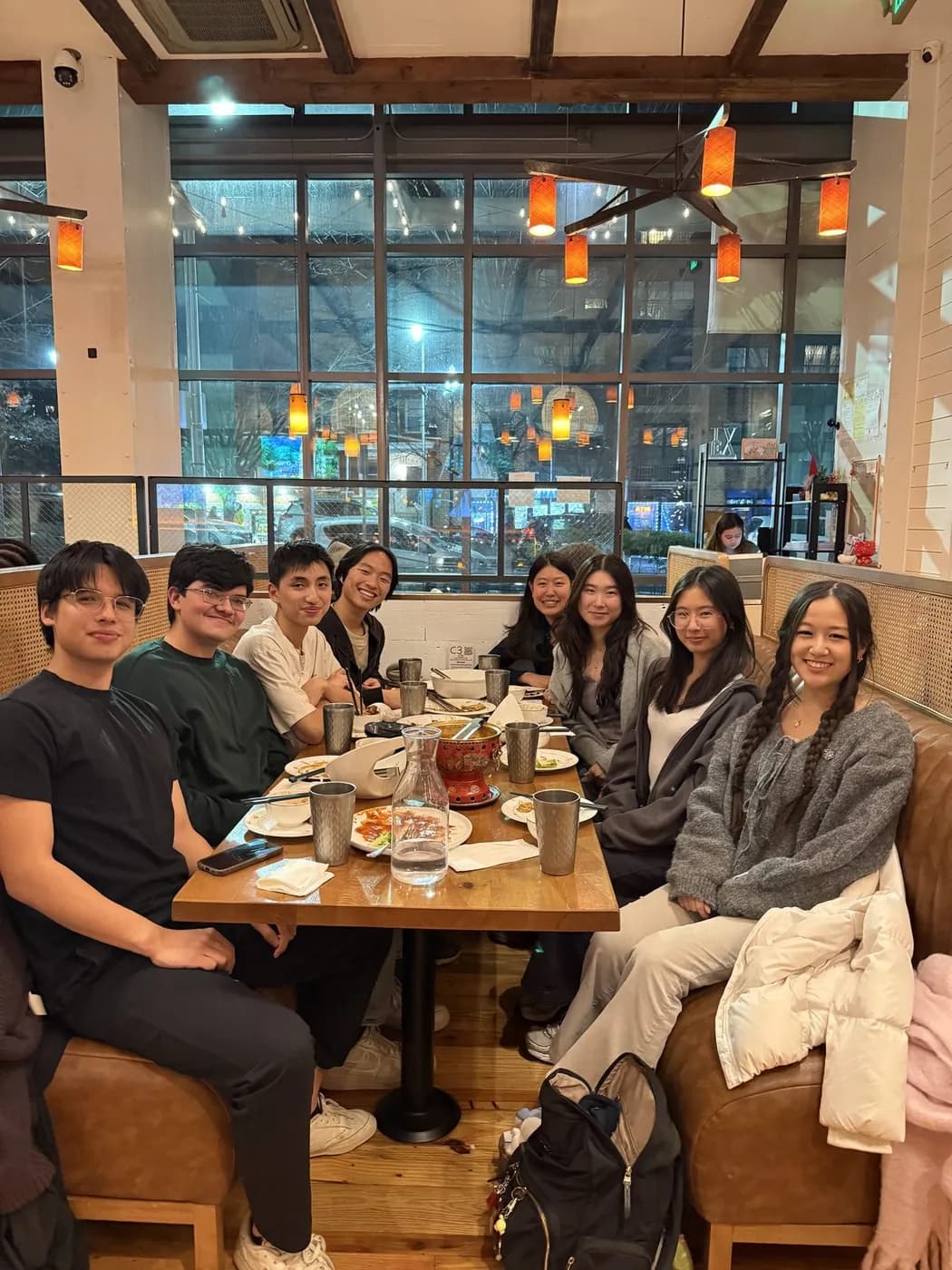 A long table of friends at dinner